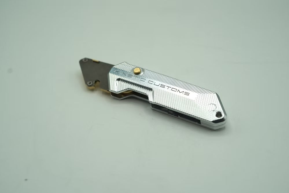 A close-up of the quick button release mechanism for fast, one-handed blade deployment on The Reaper BR-1.