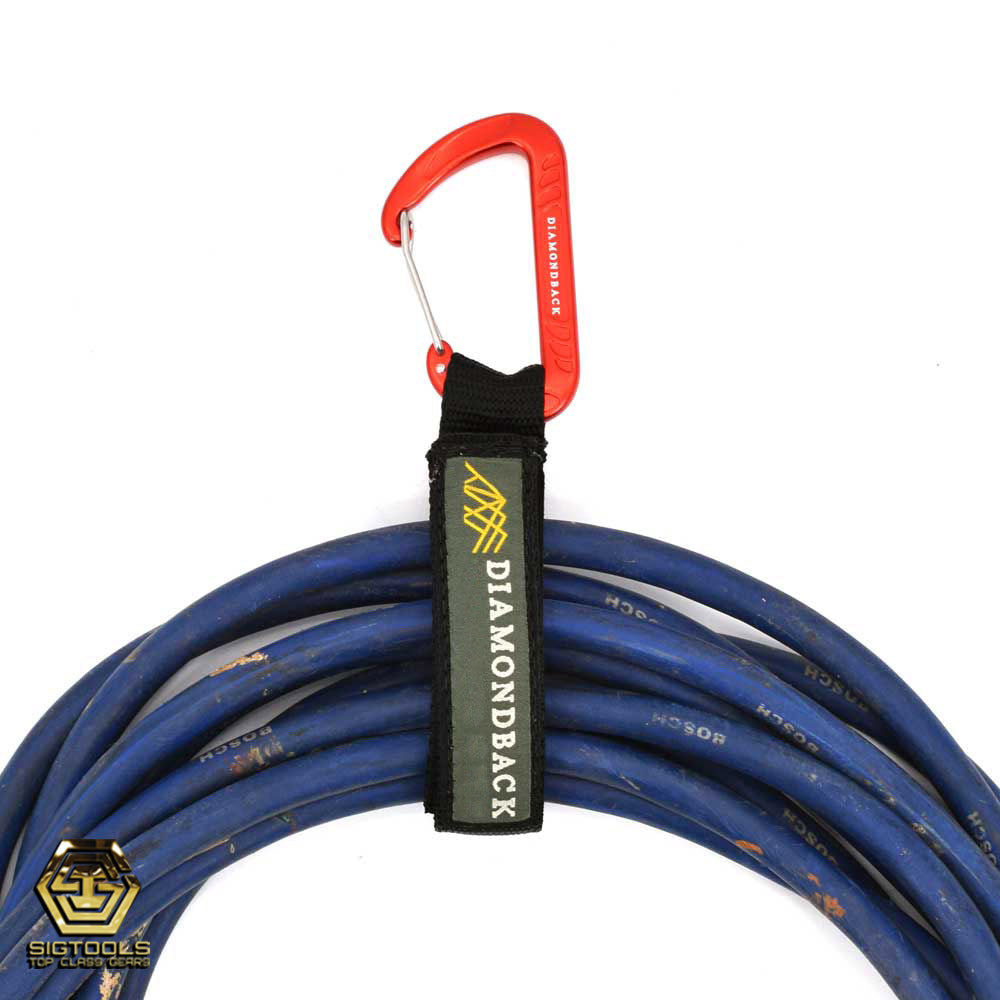 A Diamondback carabiner cord loop, carrying a coiled cable, demonstrating its practical use for securely holding and transporting cables.