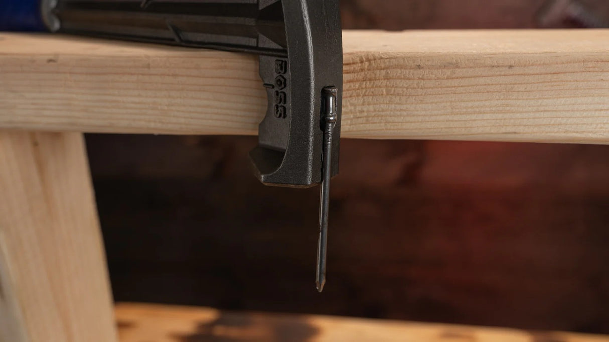 The MAG START magnetic nail slot on the Boss Hammer Blue Collar, securely holding a large duplex nail.