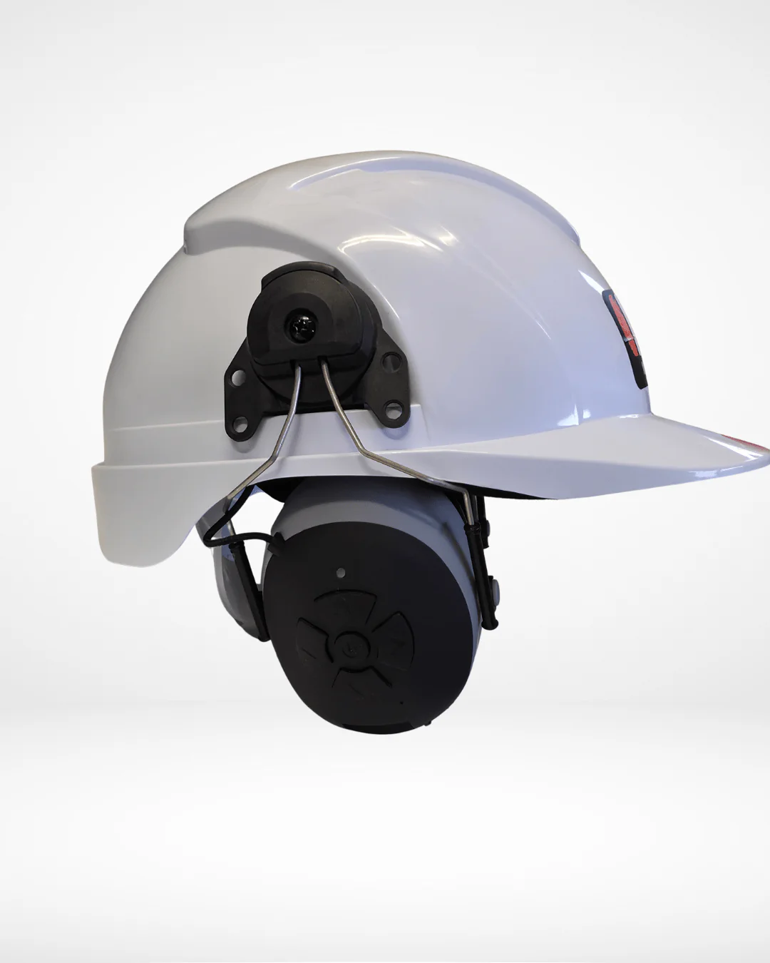 Close-up of Mufftech control buttons on helmet-mounted earmuffs showing robust build quality.