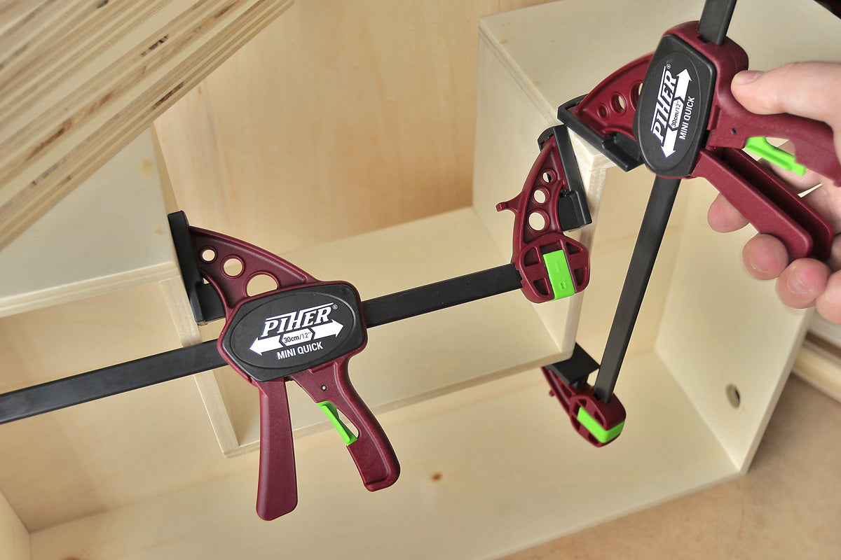 The Piher Mini Quick Clamp instantly converting from a clamp to a spreader with a single click.