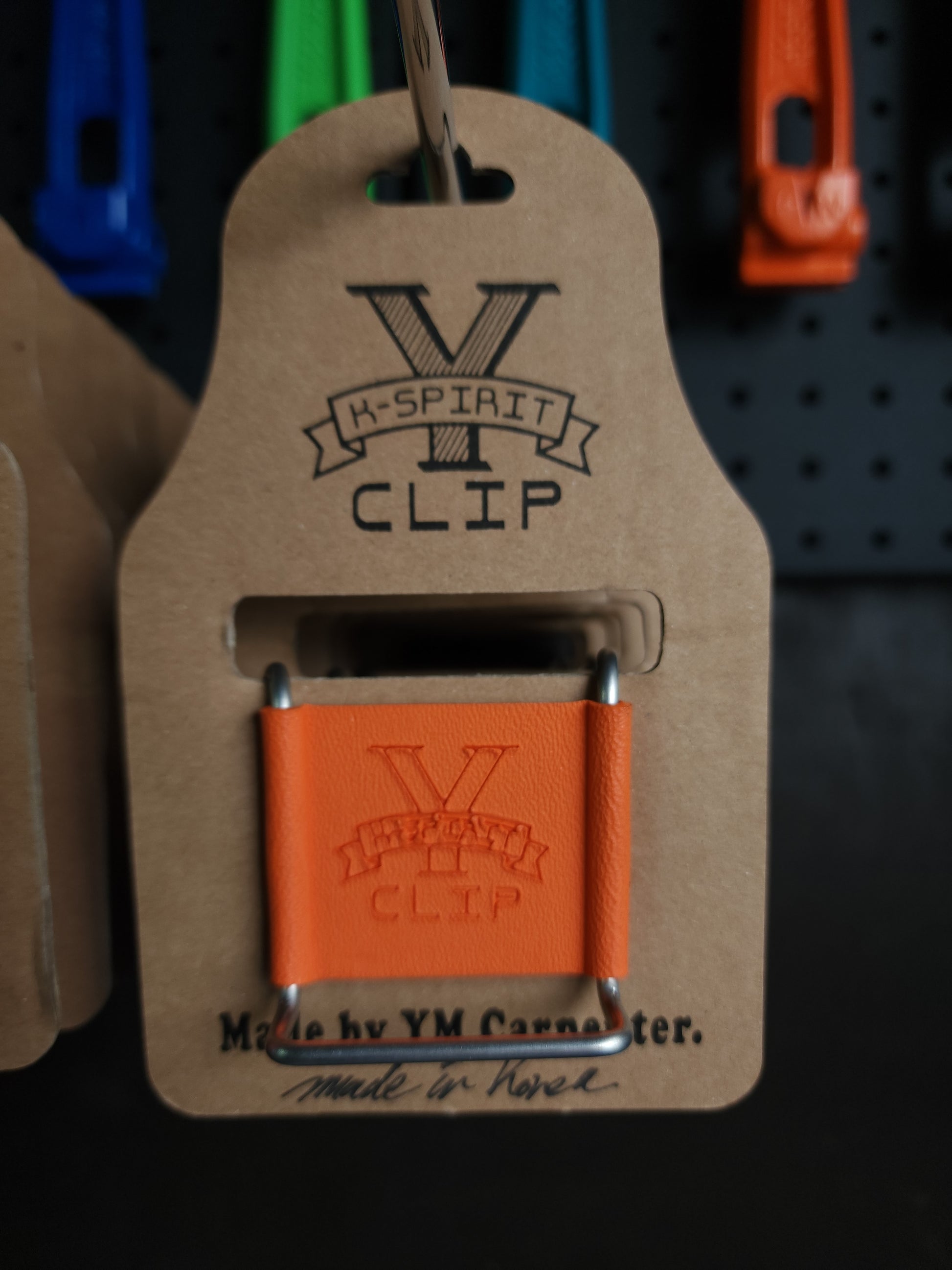 Handcrafted Y-Clip hanger by YM Carpenter displayed with a tape measure.