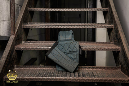 The rear perspective of a Gunmetal Grey Carpenter Tool Bag by Badger, showcasing its design and features for efficient tool storage and transport