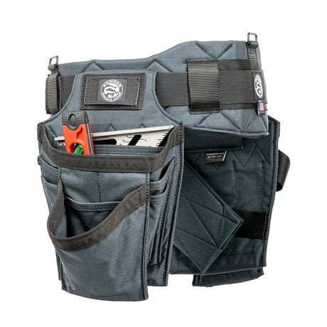 A professional finish carpenter wearing the compact Badger Trimmer V2 Tool Belt Setup during interior drywall work, demonstrating the low-profile tape measure clip and ergonomic back support.
