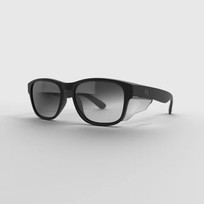 The ICON Adaptix Photochromic safety glasses featuring UV-activated lenses, a mirror finish, and adjustable polycarbonate temples.